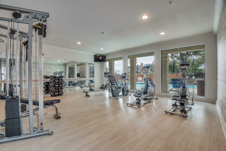 Fitness center with large windows and mirrors