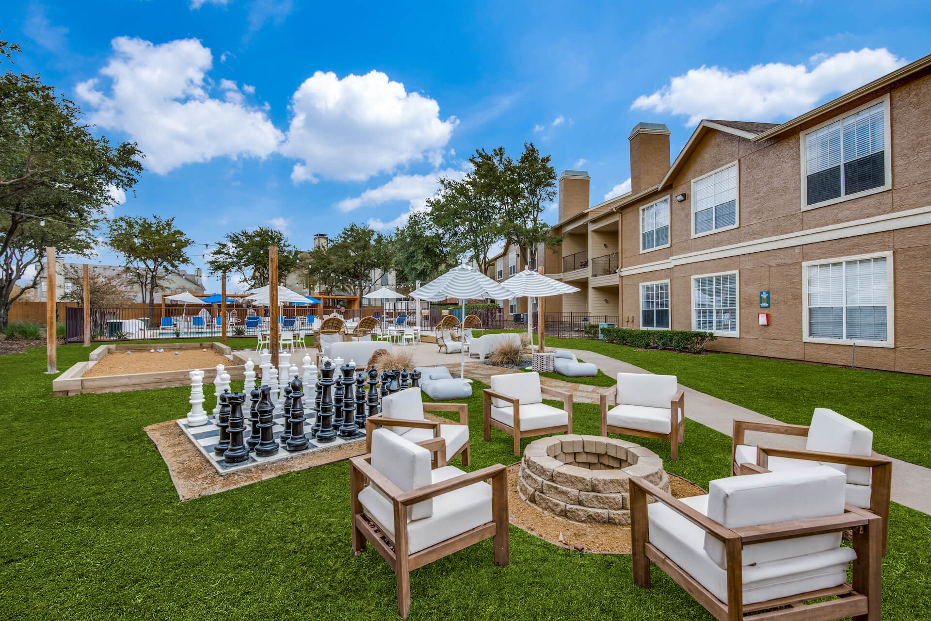 Outdoor area with firepit, outdoor chess, sand volleyball and pool