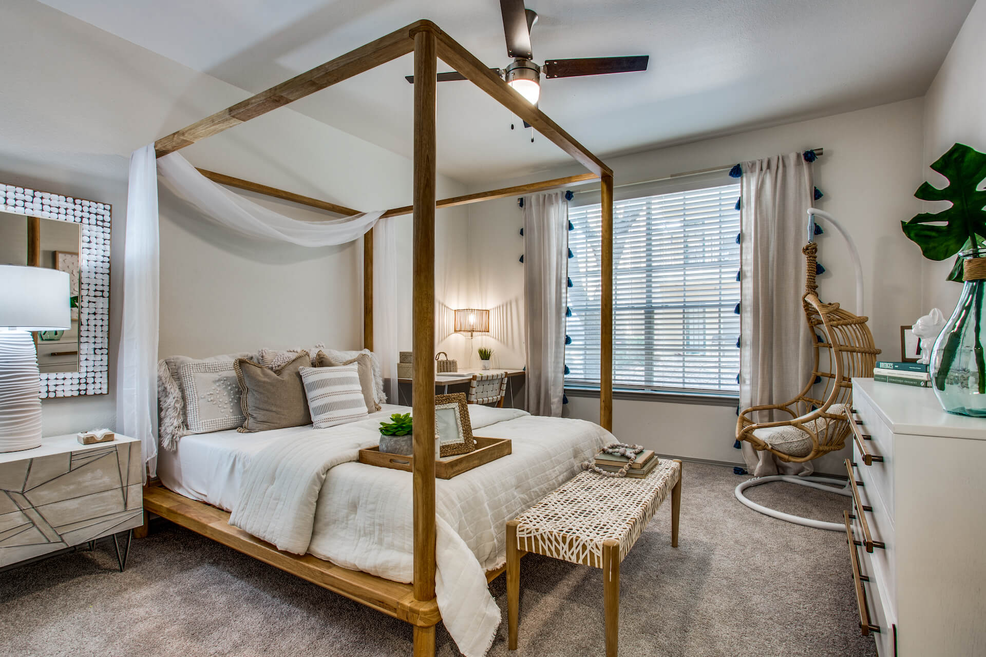 Bedroom with large window and ceiling fan